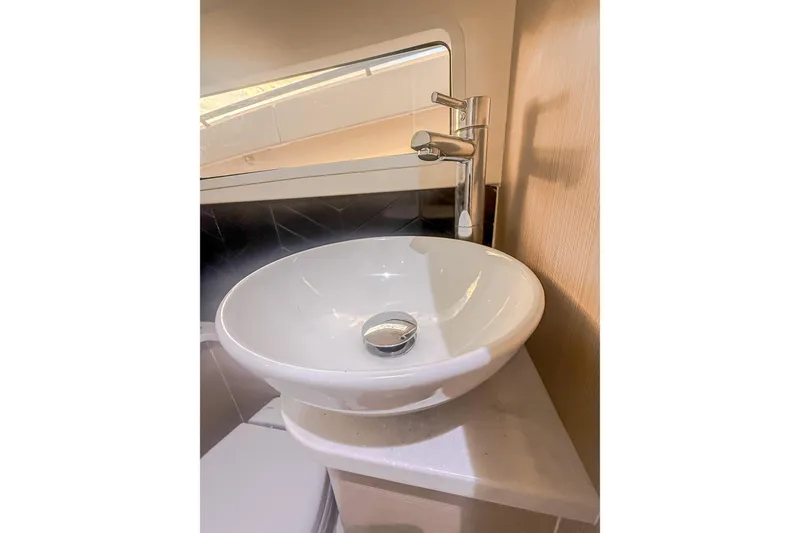 Slide: The Image of Modern sink and faucet in 2024 Scout 377 LXF boat interior. - 84