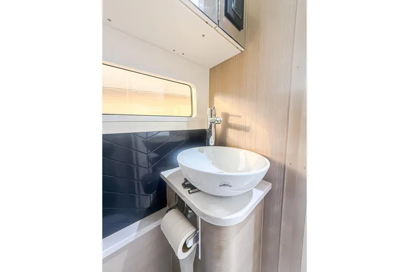 Slide: The Image of Modern bathroom sink in 2024 Scout 377 LXF boat, featuring sleek design and compact space. - 86