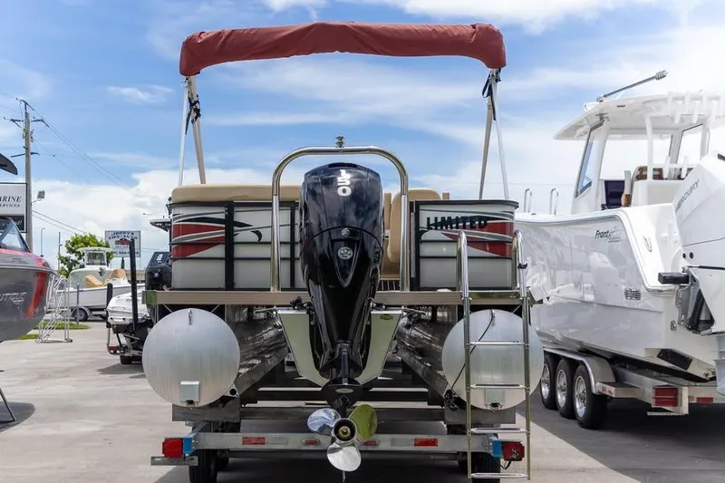 Slide: The Image of 2022 Massimo Marine P-23 MAX Limited pontoon boat with outboard motor, docked outdoors. - 3