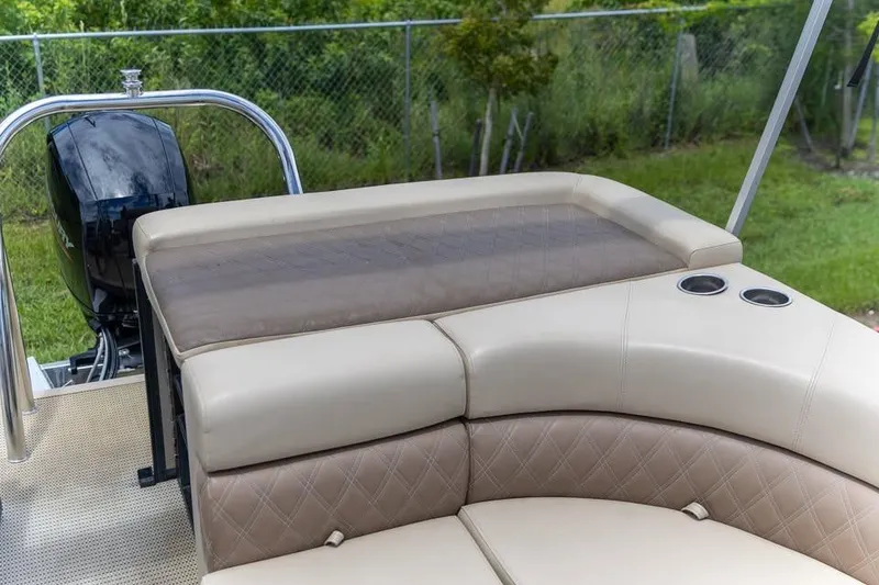Slide: The Image of 2022 Massimo Marine P-23 MAX Limited boat interior with beige seating and cup holders. - 9