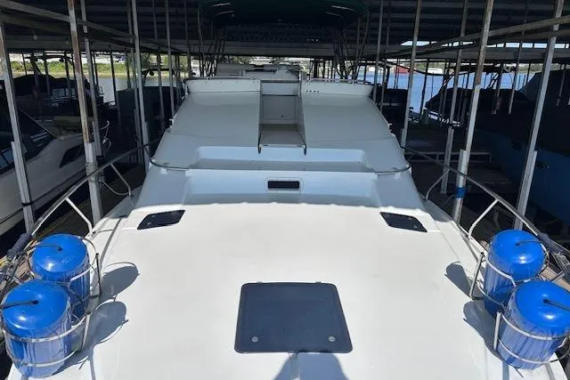 Slide: The Image of 1994 Mainship 40 Sedan Bridge yacht docked under covered marina. - 11