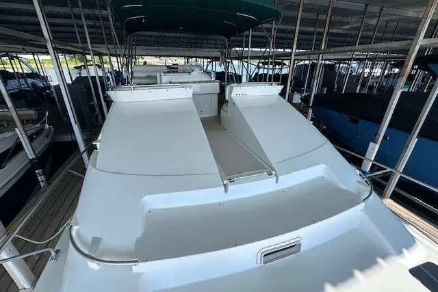 Slide: The Image of 1994 Mainship 40 Sedan Bridge yacht docked in a covered marina. - 12