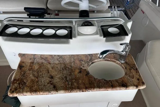 Slide: The Image of 1994 Mainship 40 Sedan Bridge helm with granite countertop and sink. - 14