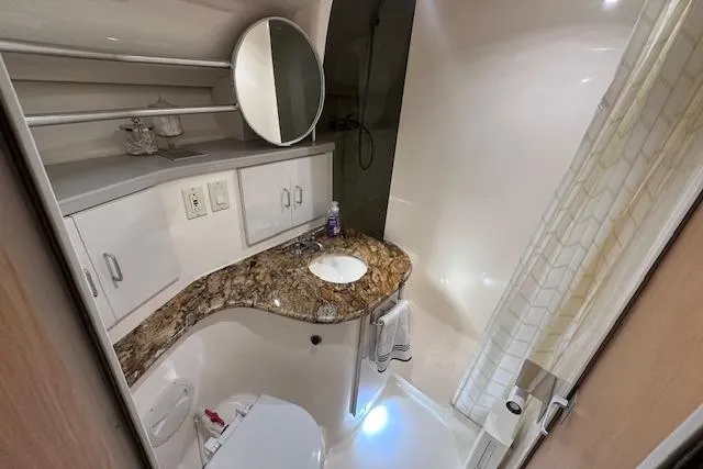 Slide: The Image of Luxurious bathroom in 1994 Mainship 40 Sedan Bridge with granite countertop and modern fixtures. - 26