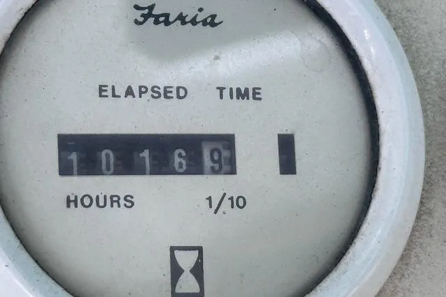 Slide: The Image of Elapsed time gauge showing 1016.9 hours on a 1994 Mainship 40 Sedan Bridge. - 39