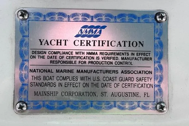 Slide: The Image of Yacht certification plaque for 1994 Mainship 40 Sedan Bridge, NMMA compliance verified. - 40