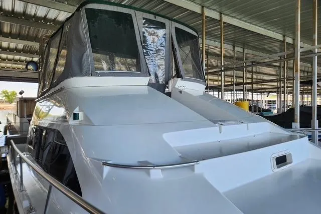 Slide: The Image of 1994 Mainship 40 Sedan Bridge yacht docked in covered marina. - 5