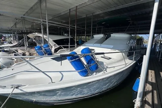 Slide: The Image of 1994 Mainship 40 Sedan Bridge docked under a covered marina. - 6