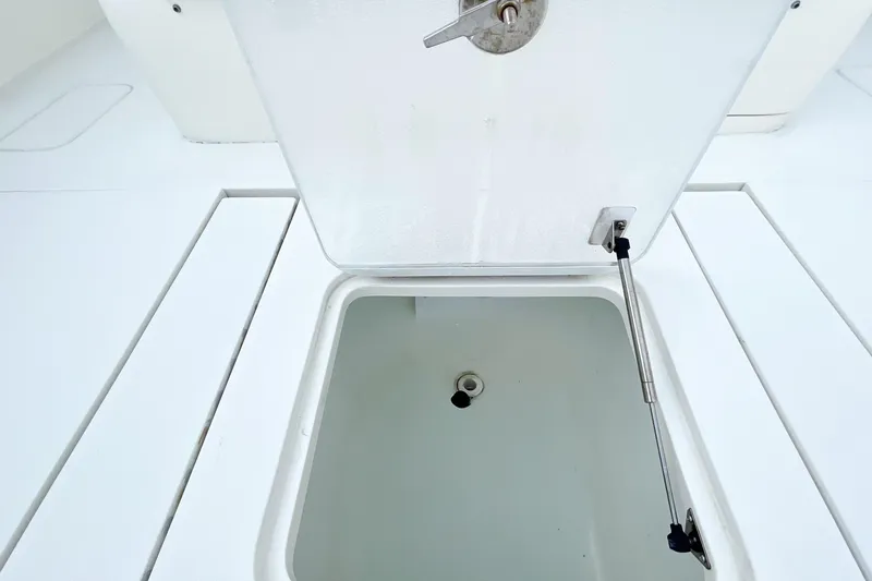 Slide: The Image of 2015 SeaVee 39Z boat storage compartments and engine access, open hatches revealing interior. - 23