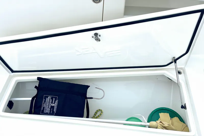 Slide: The Image of 2015 SeaVee 39Z boat interior with open storage compartments and cushioned seating. - 26