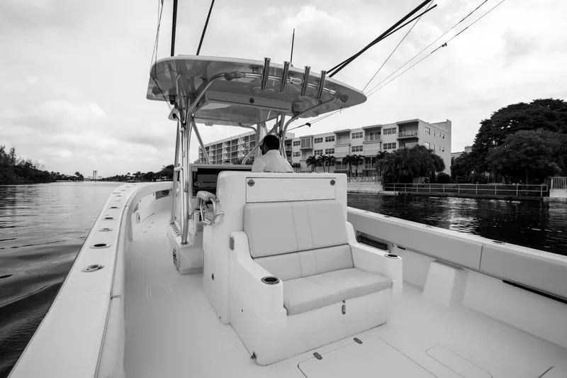 Slide: The Image of 2015 SeaVee 39Z boat interior with white seating and deck, docked at marina. - 44