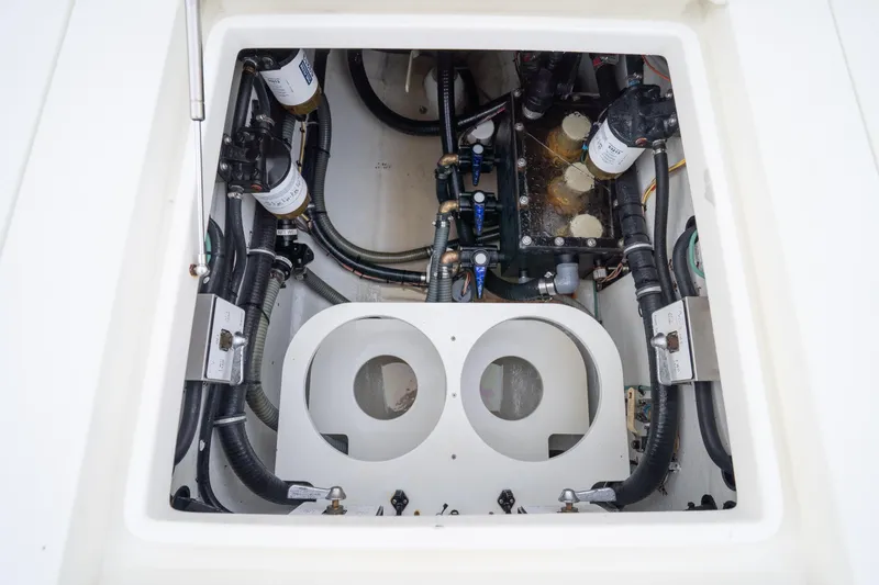 Slide: The Image of 2015 SeaVee 390Z boat storage compartment with open doors and organized tackle boxes. - 45