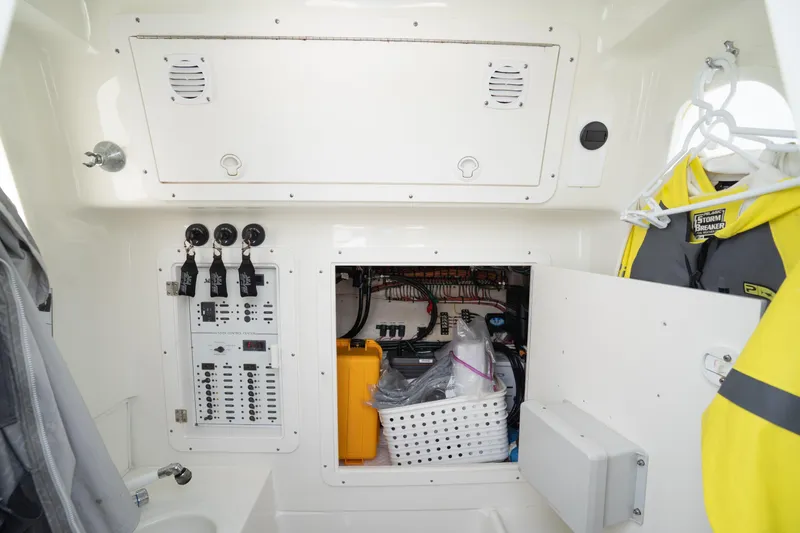 Slide: The Image of 2015 SeaVee 390Z boat with open storage compartment and cushioned seat. - 46