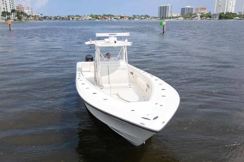 Slide: The Image of 2015 SeaVee 39Z boat on water, featuring sleek design and spacious deck. - 58