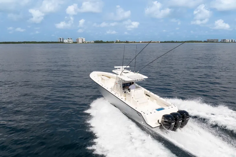 Slide: The Image of 2015 SeaVee 39Z boat cruising on open water with triple Mercury engines. - 67