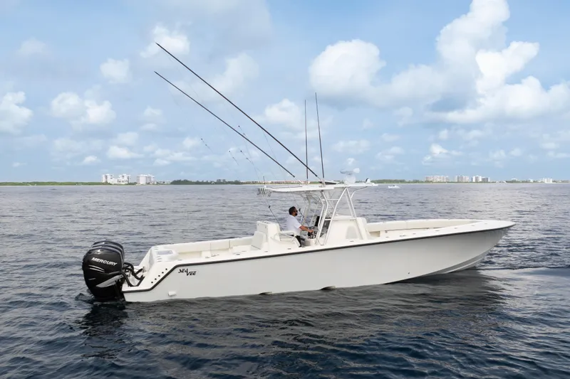 Slide: The Image of 2015 SeaVee 39Z boat on open water, featuring fishing rods and a center console. - 68