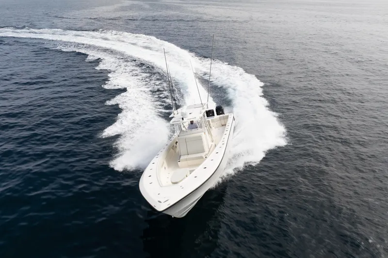 Slide: The Image of 2015 SeaVee 39Z boat on open water, equipped with fishing rods and multiple engines. - 76