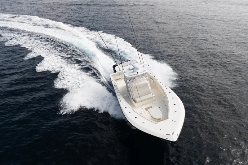 Slide: The Image of 2015 SeaVee 390Z boat cruising on open water, creating a wake. - 80