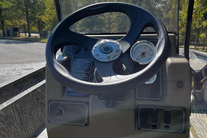 Slide: The Image of Steering console of 2026 Tracker Grizzly 1860 CC boat with RPM gauge. - 6