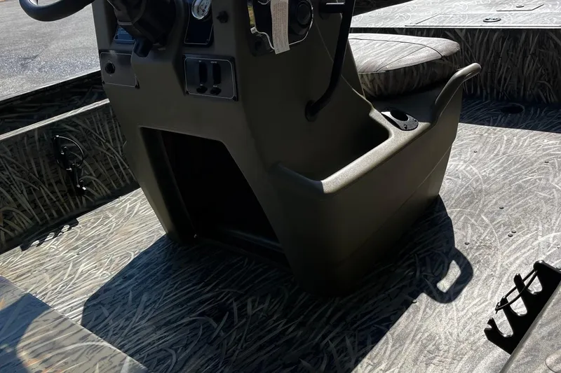 Slide: The Image of 2026 Tracker Grizzly 1860 CC boat interior with camo pattern and steering console. - 8