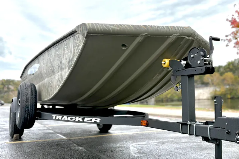 Slide: The Image of 2026 Tracker Grizzly 1650 T Prairie Wings Edition boat on trailer, side view. - 10