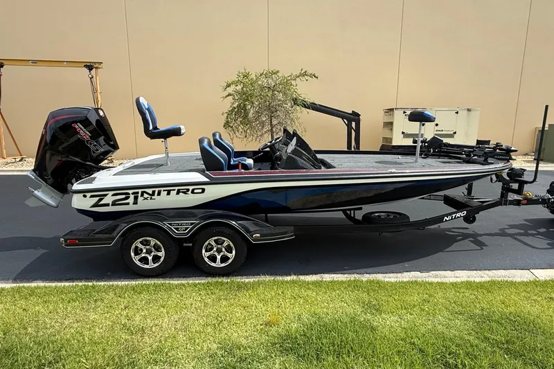 Slide: The Image of 2026 Nitro Z21 XL Pro boat on trailer, parked outdoors. - 4