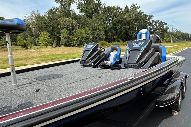 Slide: The Image of 2026 Nitro Z21 XL Pro boat with sleek design and blue-accented seats on a sunny day. - 5