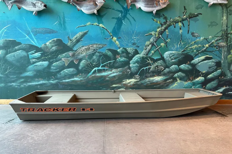 The Image of 2026 Tracker Grizzly 14 Jon boat displayed against aquatic-themed mural. - 0