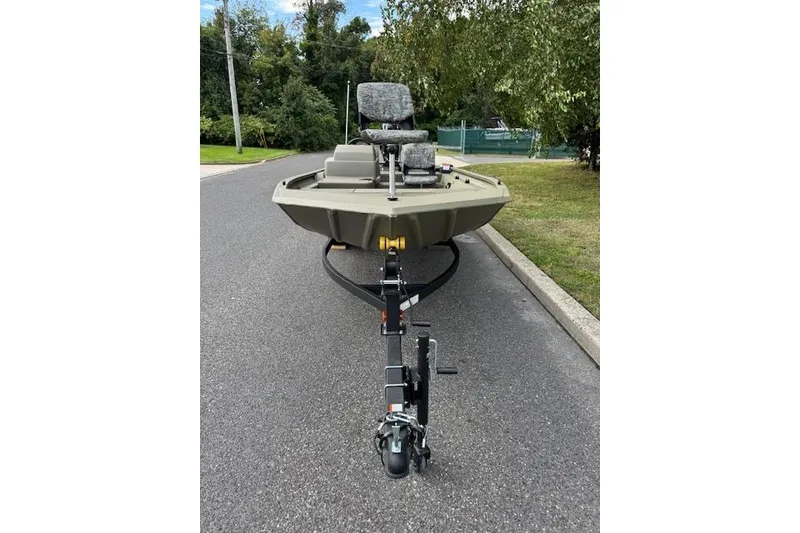 Slide: The Image of 2026 Tracker Grizzly 1754 SC boat on trailer, parked on a suburban street. - 4