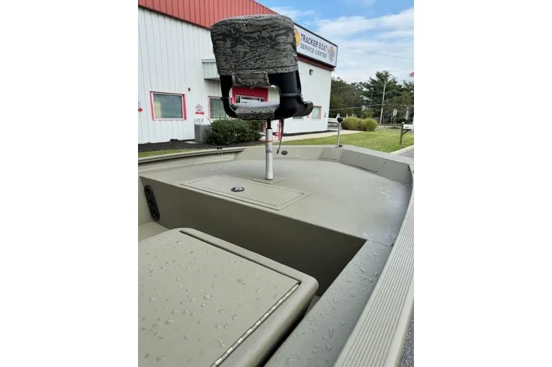 Slide: The Image of 2026 Tracker Grizzly 1754 SC boat with camo seat at service center. - 5