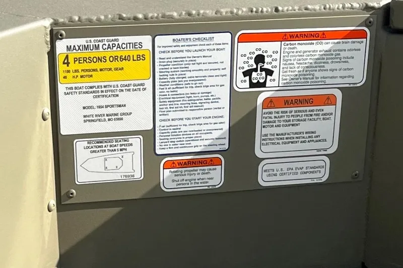Slide: The Image of Safety and capacity labels on 2026 Tracker Grizzly 1654 T Sportsman boat. - 10