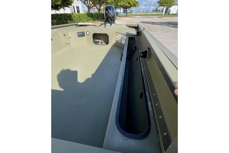 Slide: The Image of 2026 Tracker Grizzly 1654 T Sportsman boat interior with storage compartment. - 4