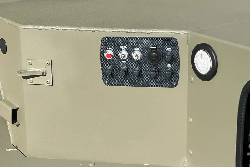 Slide: The Image of Control panel on 2026 Tracker Grizzly 1654 T Sportsman boat, featuring switches and buttons. - 6