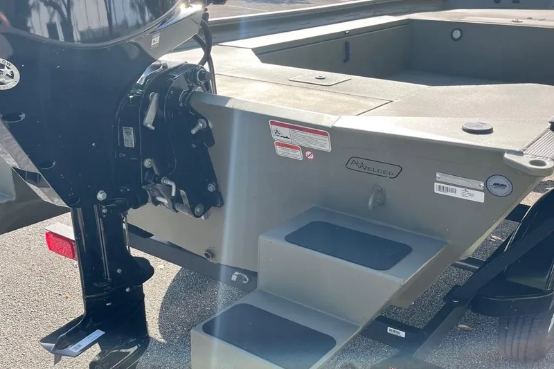 Slide: The Image of 2026 Tracker Grizzly 1654 T Sportsman boat, rear view with motor and welded hull. - 7