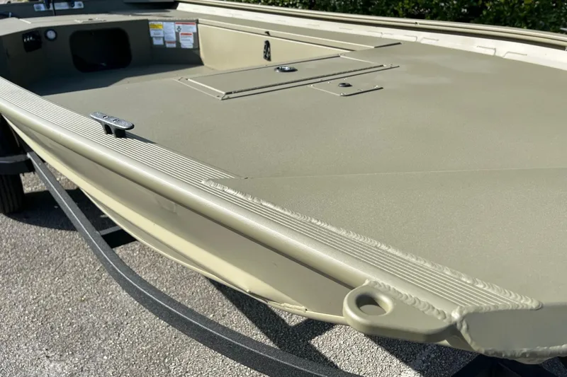 Slide: The Image of 2026 Tracker Grizzly 1654 T Sportsman boat, showcasing deck and storage compartments. - 8