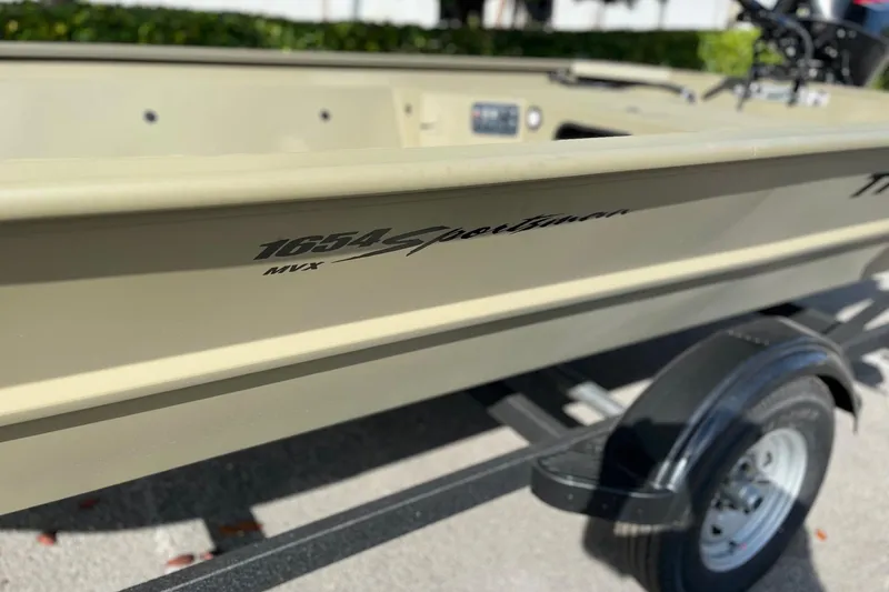 Slide: The Image of 2026 Tracker Grizzly 1654 T Sportsman boat on trailer, close-up view. - 9