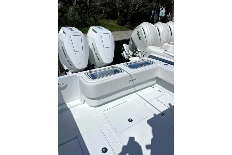 Slide: The Image of 2026 Contender 32 ST boat with Mercury and Yamaha engines, featuring a sleek white deck. - 12