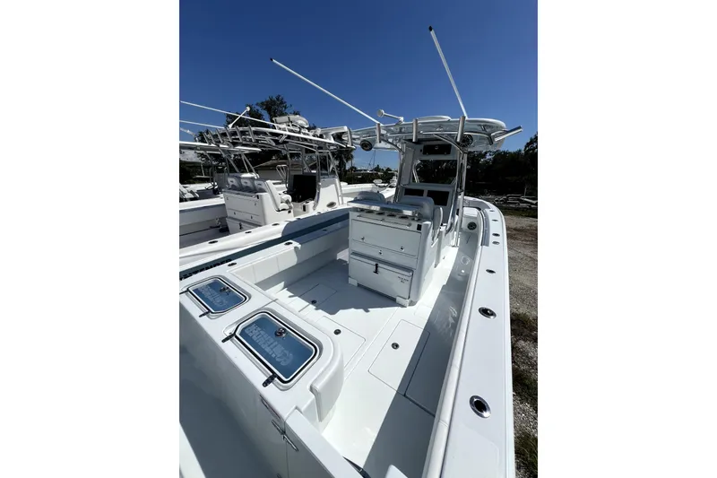 Slide: The Image of 2026 Contender 32 ST boat with sleek design and modern features under clear blue sky. - 3