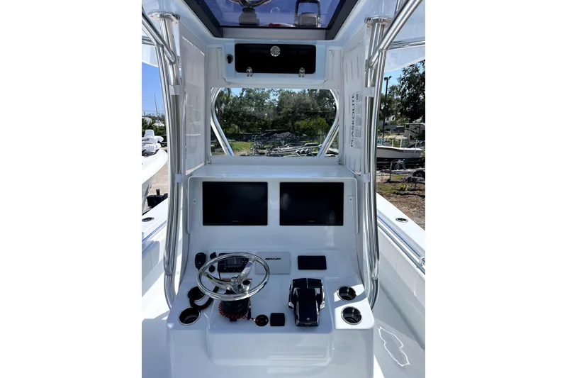 Slide: The Image of 2026 Contender 32 ST boat helm with dual screens and steering wheel. - 6
