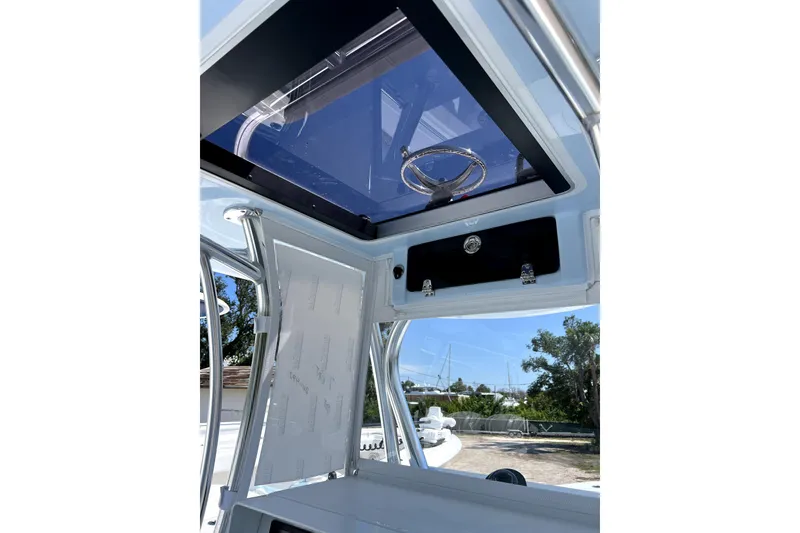 Slide: The Image of 2026 Contender 32 ST boat console with steering wheel and storage compartment. - 7