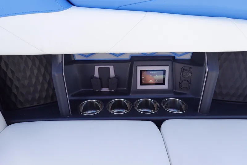 Slide: The Image of Interior of 2025 Malibu M230 boat with touchscreen controls and cup holders. - 22