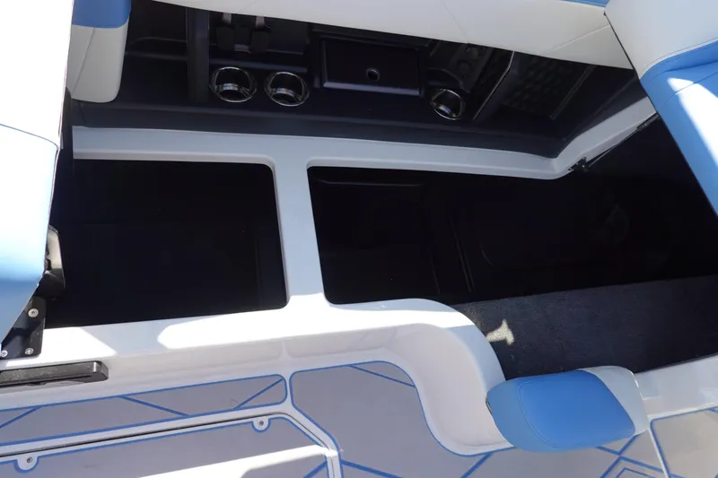 Slide: The Image of Interior view of 2025 Malibu M230 boat with open storage compartments. - 31