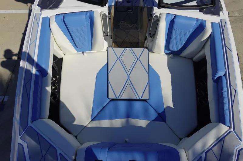 Slide: The Image of 2025 Malibu M230 boat interior with blue and white seating and stylish design. - 35