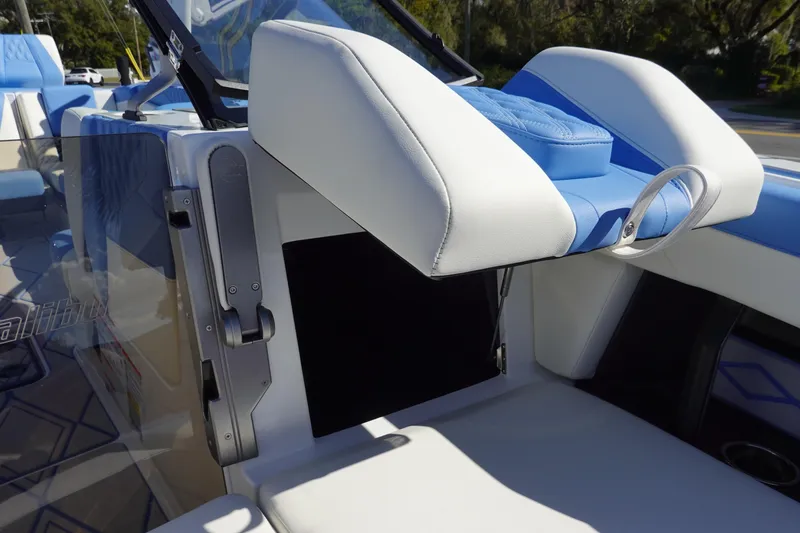 Slide: The Image of 2025 Malibu M230 boat interior with blue and white seating and modern design elements. - 40