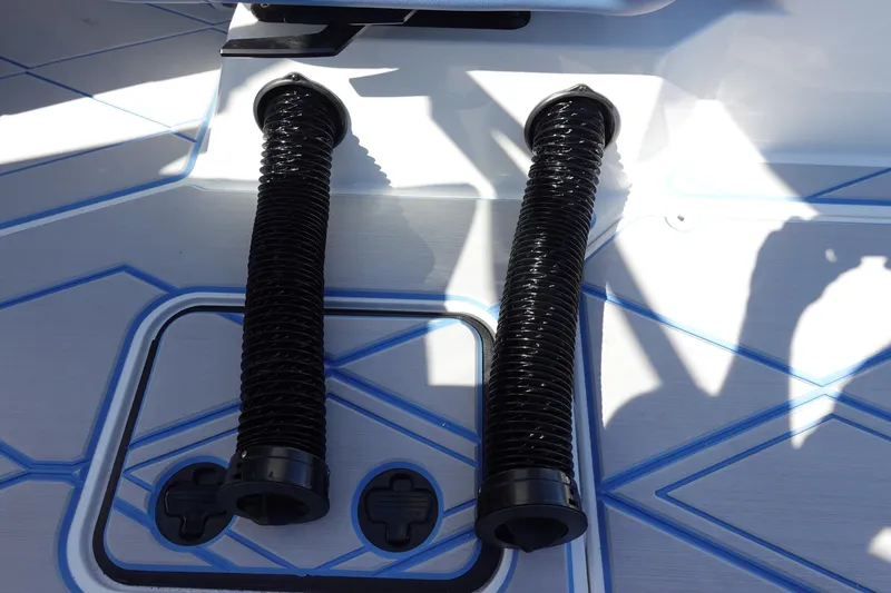 Slide: The Image of 2025 Malibu M230 boat deck with two black exhaust hoses. - 42