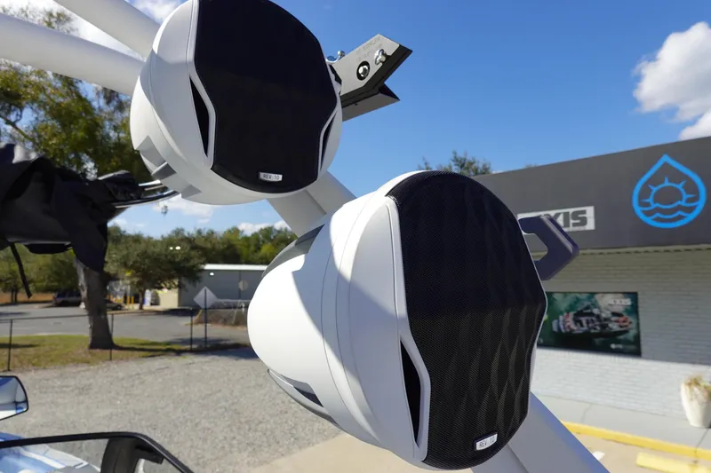 Slide: The Image of Close-up of Malibu M230 2025 boat speakers mounted outdoors, with a clear sky background. - 45