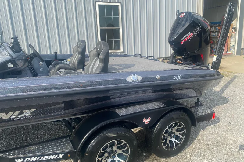 Slide: The Image of 2026 Phoenix 21 XE boat with dual seats and powerful outboard motor. - 10