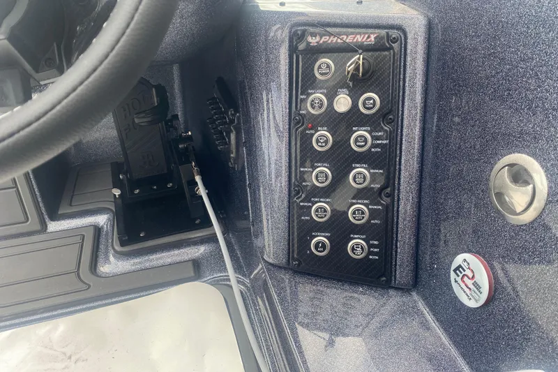 Slide: The Image of Control panel of 2026 Phoenix 21 XE boat with steering wheel and switches. - 15