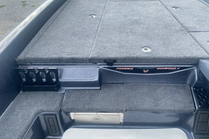 Slide: The Image of 2026 Phoenix 21 XE boat interior with carpeted deck and storage compartments. - 16