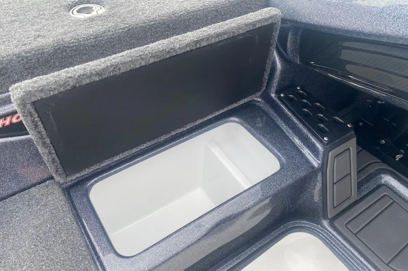 Slide: The Image of 2026 Phoenix 21 XE boat storage compartment with open lid and organized interior layout. - 18